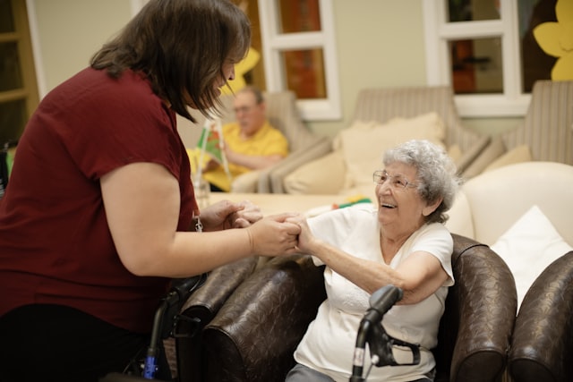 Family members gathered around a table looking at a tablet together, planning care